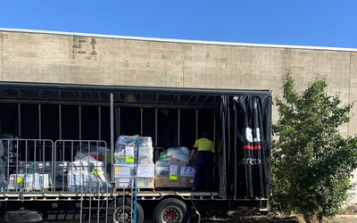Donations for flood victims in New South Wales being loaded onto a truck for delivery.